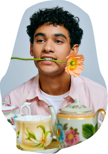 A creator with a flower in his mouth